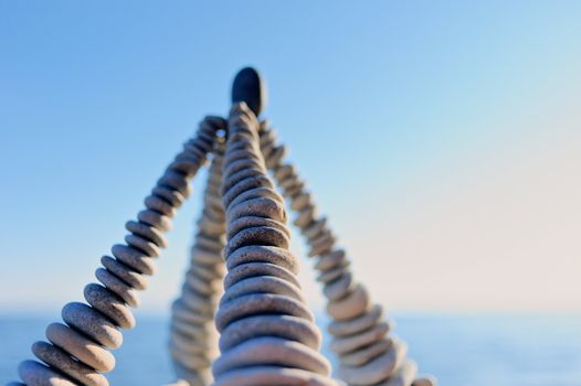 Pyramidal group of small pebbles in the balance on the seacoast