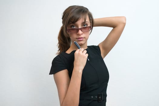 The young girl in glasses on a white background