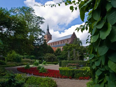 Odense the third largest city in Denmark as viewed from a green park garden
