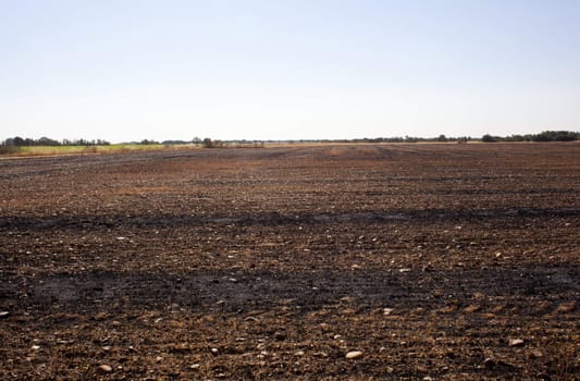 The dry grass in the field burned