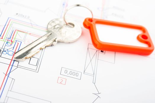 Concept of housing. Key on a blueprint .
