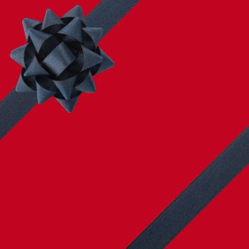 Black bow and ribbons over red background