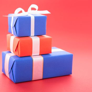 Gift boxes with a bows, isolated on red background