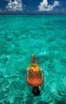 Man snorkeling in crystal clear turquoise water at tropical beach