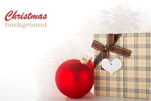 Gift box and Christmas tree decorations on white background