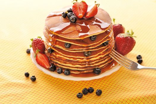 Delicious freshly prepared pancakes with strawberry and blueberries