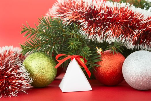 Christmas tree and decorations on red background.