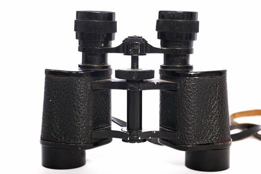 Closeup detail of a pair of binoculars standing upright isolated on white