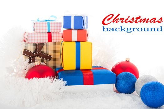 Gift box and Christmas tree decorations on a snow.