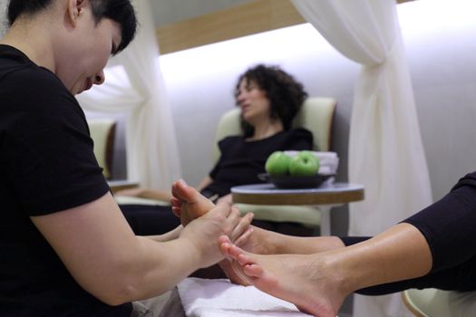 Foot massage and care in a beauty salon