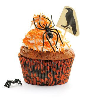 Halloween cupcake with whipped cream and decoration isolated on white