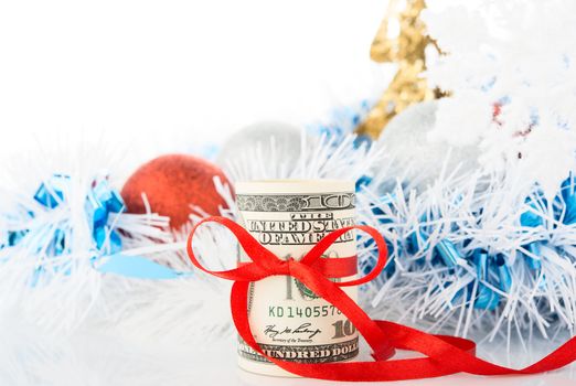 Money and Christmas decorations on white background.