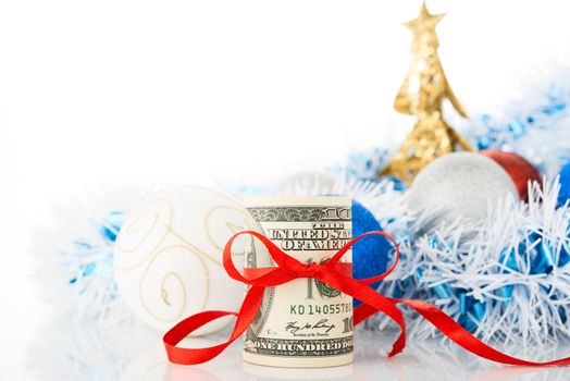 Money and Christmas decorations on white background.
