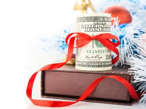 Money, gift box and Christmas decorations on white background.