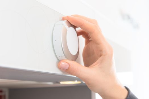 Hand changes program ventilation on kitchen