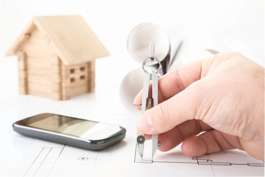 architect hand with tool and smartphone