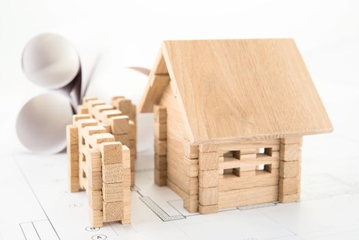 wooden house on a construction plan for house building