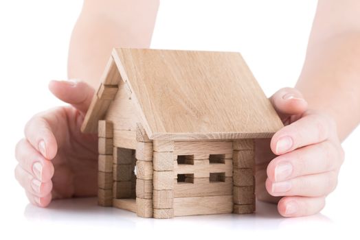 female hands barrier a small wooden house