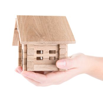 Small wooden house in a hand