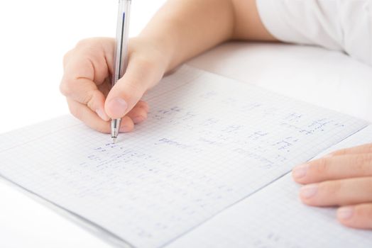 Child hands writing a homework by closeup