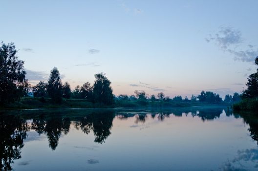 beautiful sunset on a mountain lake in summer