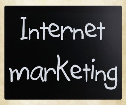 "Internet marketing" handwritten with white chalk on a blackboard