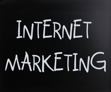 "Internet marketing" handwritten with white chalk on a blackboard