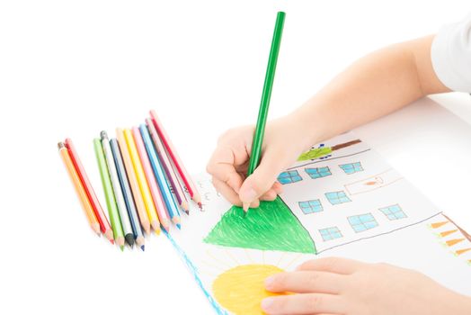 Child drawing a home with pencil