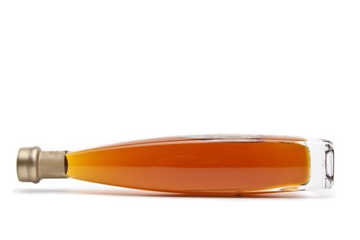 Alcohol cognac in a closed bottle on white background