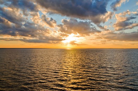 beautiful sunset over the smooth surface of a mountain lake