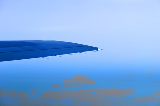 wing of an airplane and low clouds