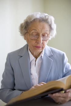 Elderly woman studying the Bible
