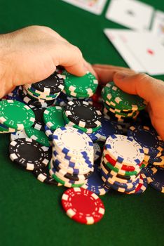 Poker player raking a big pile of chips