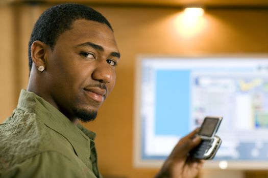 African American young adult text messaging on cell phone