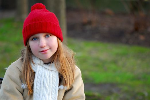 Portrait of a young girl sitting on a bench