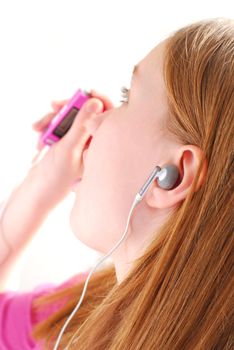 Young girl listening to music on her mp3 player white background