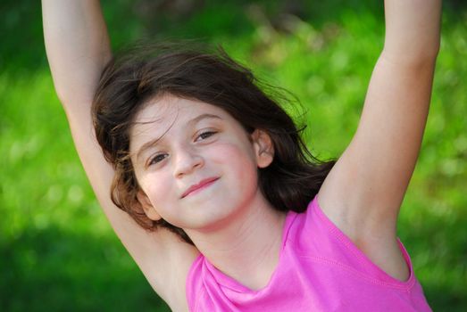 Portrait of a young girl playing on a playground at summertime