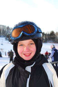 Portrait of a happy girl on downhill ski resort