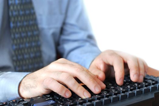 Closeup of man's hands typing on a keyboard
