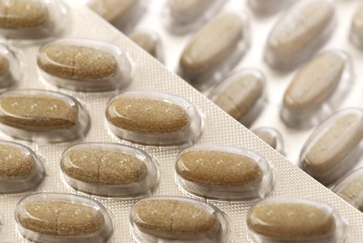 Background of herbal supplement pills close up