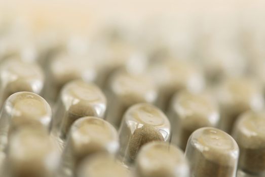 Background of herbal supplement pills close up