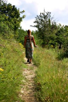 The young woman goes on wood road