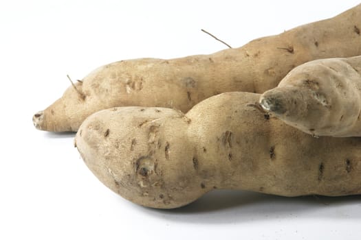 agriculture sweet potatoes closeup isolated in white