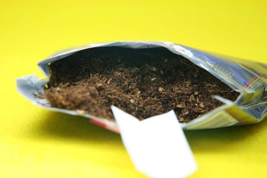 handrolling tobacco package in yellow background