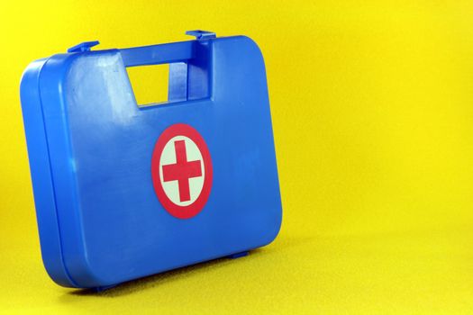 helth and safe concepts first aid box in yellow background