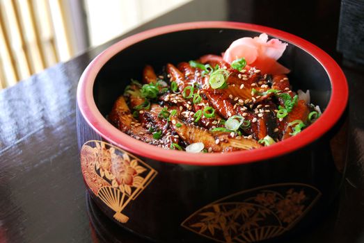 Gourmet japanese food barbequed eel served in a decorated wooden bowl
