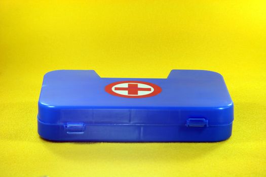 helth and safe concepts first aid box in yellow background