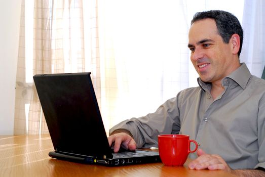 Man sitting at a desk and looking into his computer