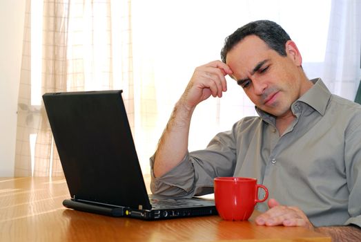 Man sitting at a desk and looking into his computer