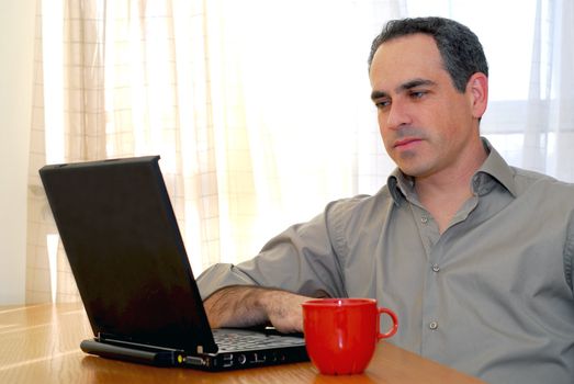 Man sitting at a desk and looking into his computer